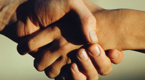 Close-up image of two people shaking hands.