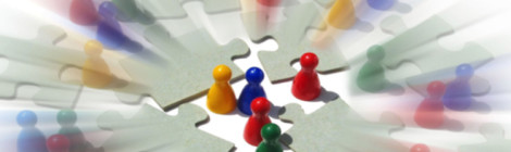 Multicolored board game player pawns are assembled like groups of people in conversation amid disconnected puzzle pieces.